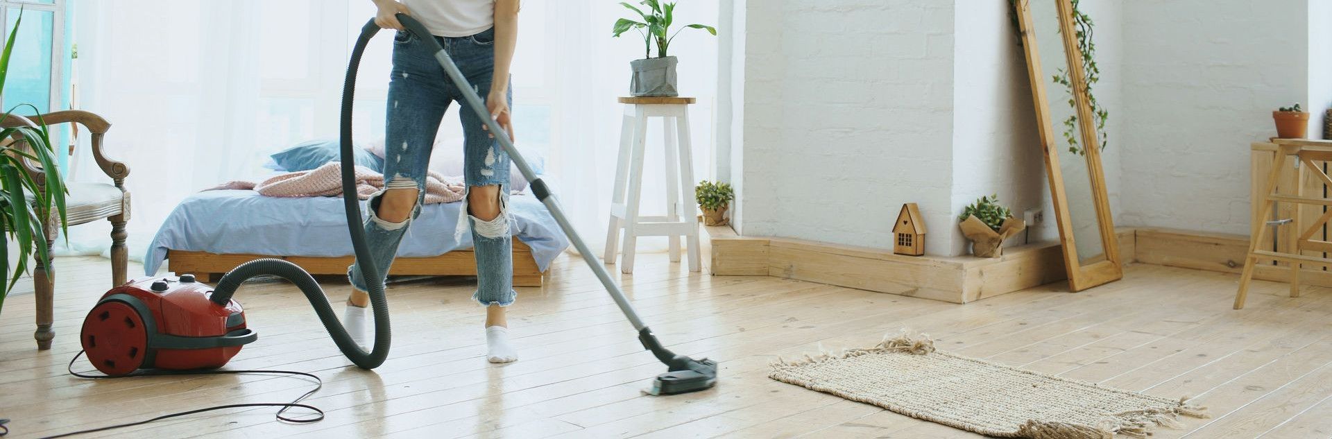 A woman vacuuming a bright, modern living room